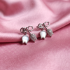 Elegant Silver-Tone Bow Earrings with Crystal & White Leaf Charms
